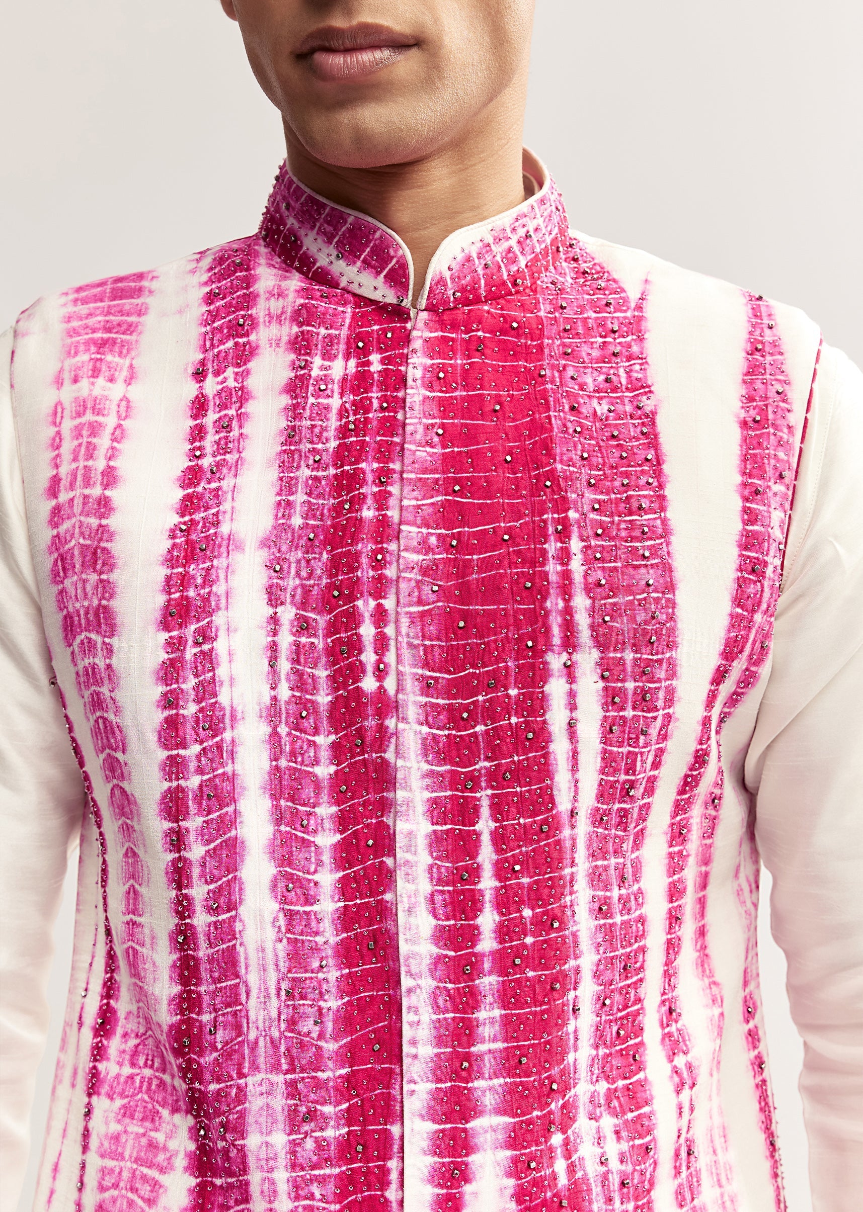 Vibrant Bandhani Festive Couple Set – Bandhani Cape Skirt Set For Her And Pink Silk Tie-Dye Kurta Jacket Set For Him