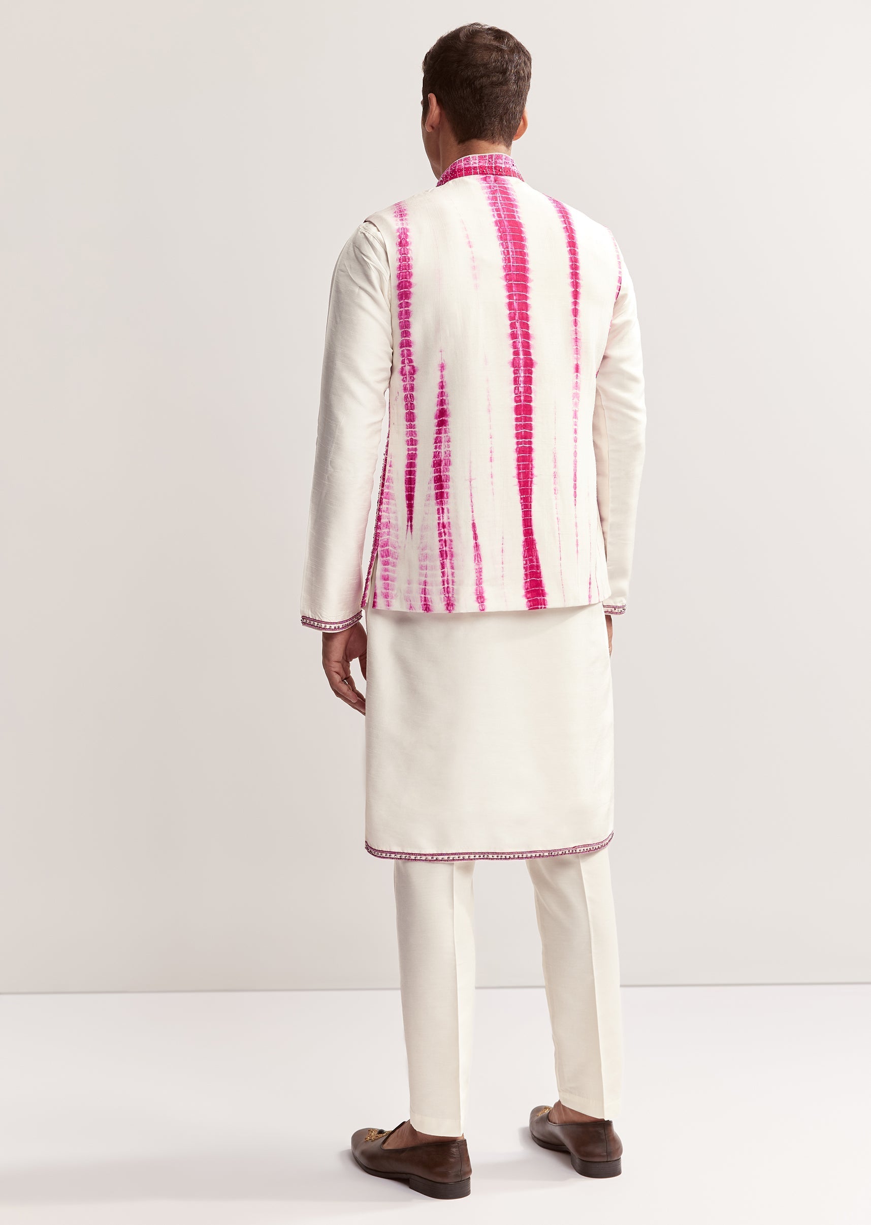 Vibrant Bandhani Festive Couple Set – Bandhani Cape Skirt Set For Her And Pink Silk Tie-Dye Kurta Jacket Set For Him