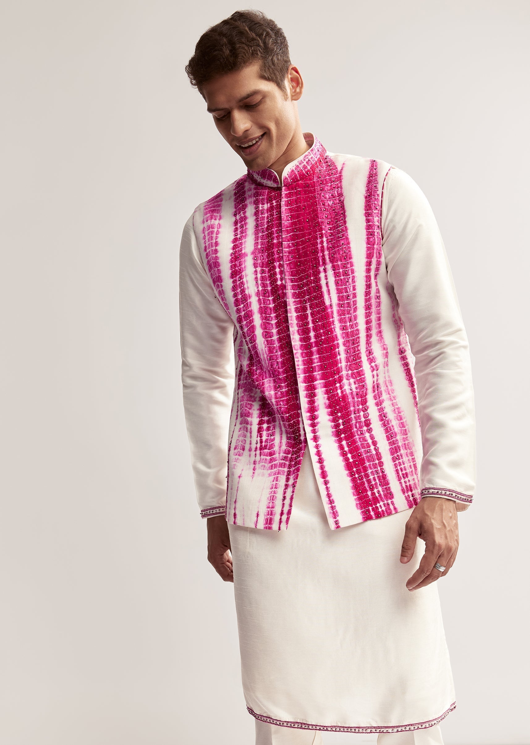 Vibrant Bandhani Festive Couple Set – Bandhani Cape Skirt Set For Her And Pink Silk Tie-Dye Kurta Jacket Set For Him
