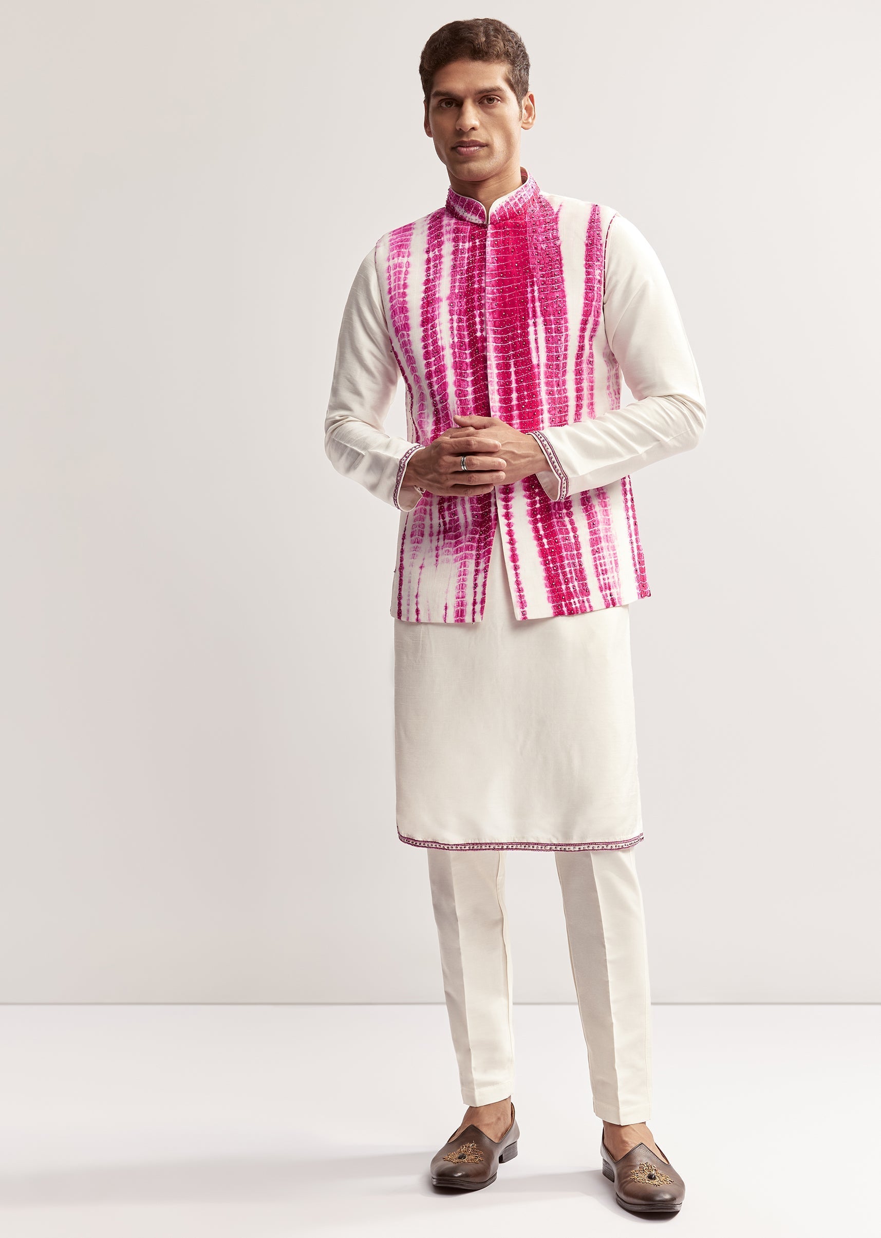 Vibrant Bandhani Festive Couple Set – Bandhani Cape Skirt Set For Her And Pink Silk Tie-Dye Kurta Jacket Set For Him